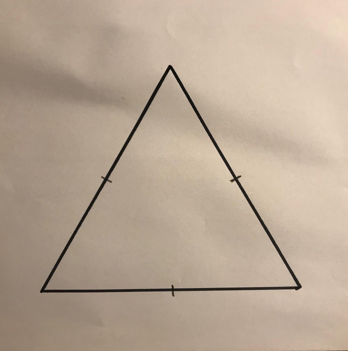Outline sketch of an equilateral triangle with tick marks indicating the midpoint of each side.