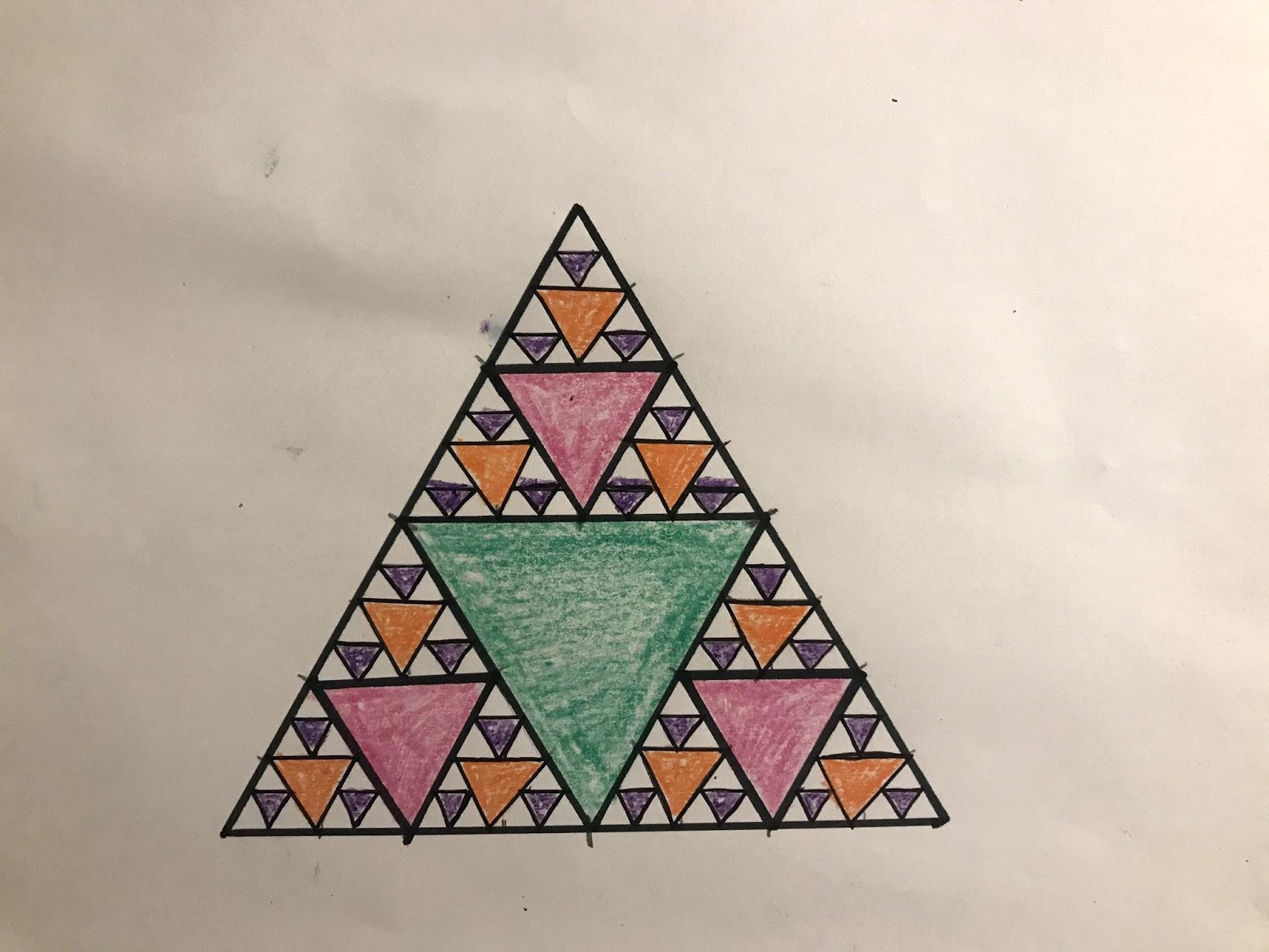 A completed Sierpinski Triangle containing a large green triangle, three medium pink triangles, nine small orange triangles, and twenty-seven tiny purple triangles.
